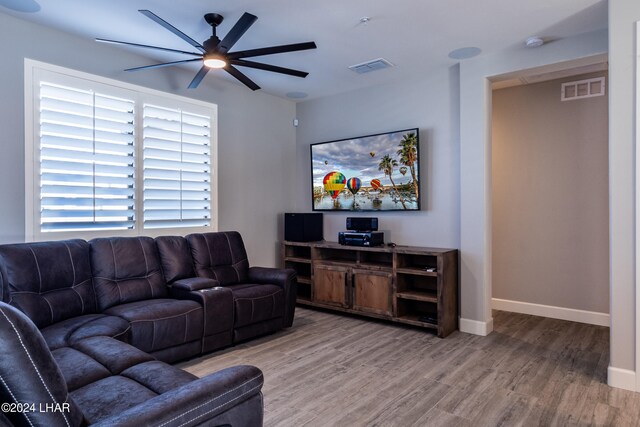 living room featuring hardwood / wood-style flooring and ceiling fan