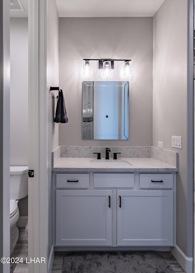 bathroom featuring vanity and toilet