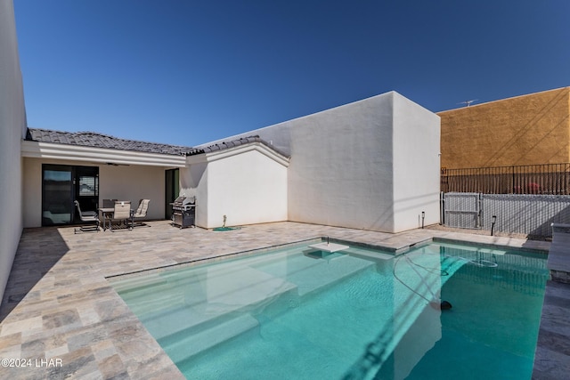 view of pool featuring grilling area and a patio area