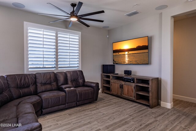 living room with ceiling fan and light wood-type flooring