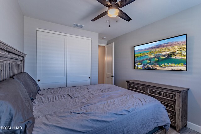 bedroom with ceiling fan and a closet