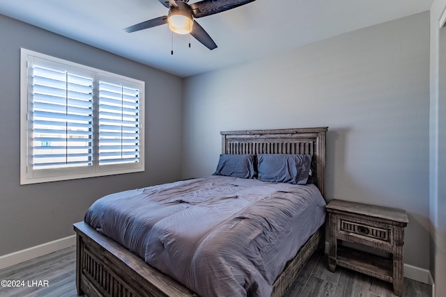 bedroom with hardwood / wood-style flooring and ceiling fan