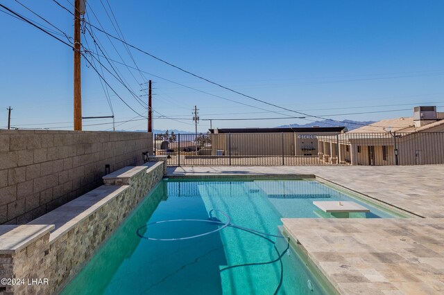 view of swimming pool with a patio