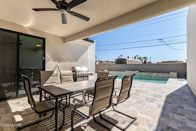 view of patio / terrace with a fenced in pool, a grill, and ceiling fan