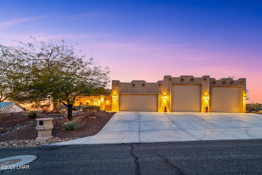 pueblo-style home featuring a garage