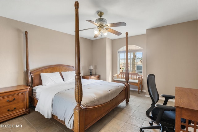 bedroom with light tile patterned flooring, a ceiling fan, and baseboards