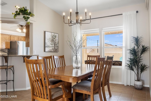 dining area featuring light tile patterned floors, visible vents, baseboards, and an inviting chandelier