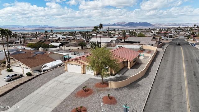 birds eye view of property with a mountain view and a residential view