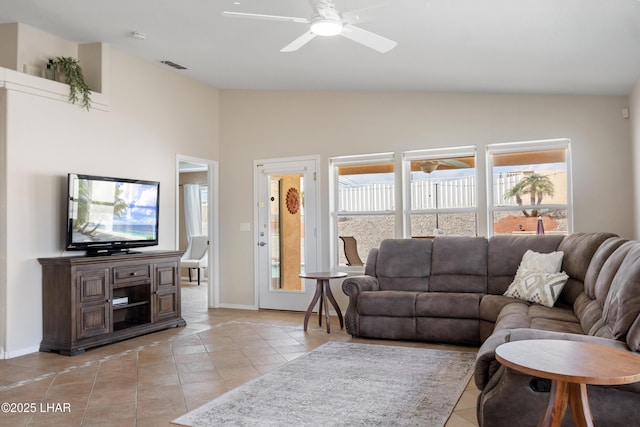 living area with light tile patterned floors, visible vents, and ceiling fan