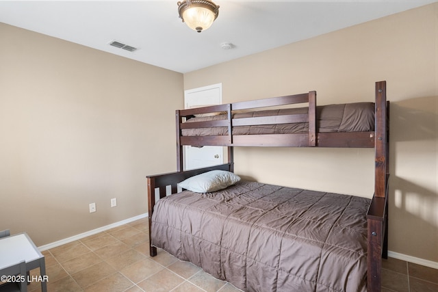 bedroom featuring tile patterned floors, visible vents, and baseboards