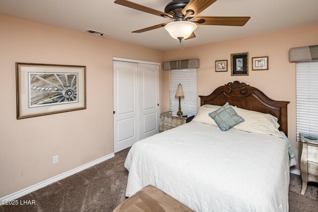 carpeted bedroom with ceiling fan and a closet