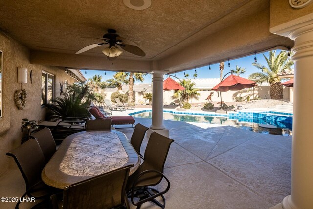 view of patio with a fenced in pool and ceiling fan