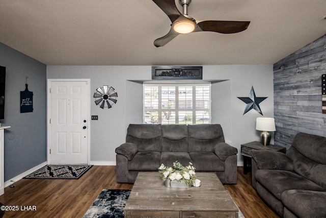 living room with hardwood / wood-style floors, vaulted ceiling, and ceiling fan