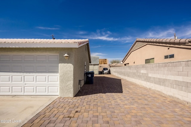 view of side of property with a garage