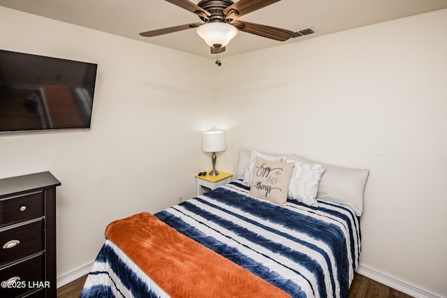 bedroom with ceiling fan and dark hardwood / wood-style flooring