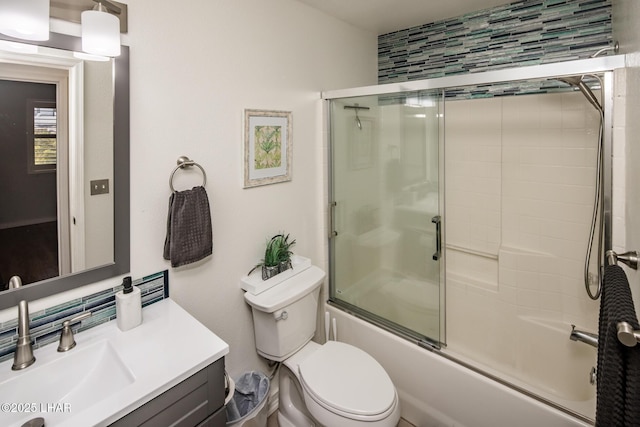 full bathroom with toilet, vanity, and shower / bath combination with glass door