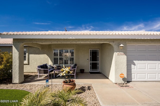 view of exterior entry with a garage