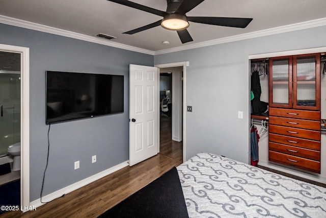 bedroom with connected bathroom, a closet, ceiling fan, crown molding, and dark hardwood / wood-style floors