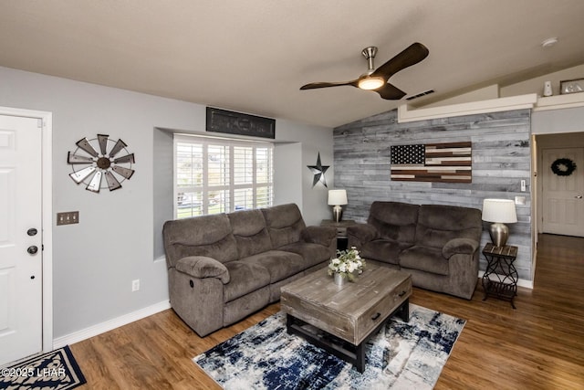 living room with hardwood / wood-style flooring, vaulted ceiling, and ceiling fan