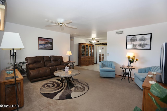 living room featuring carpet, visible vents, and ceiling fan