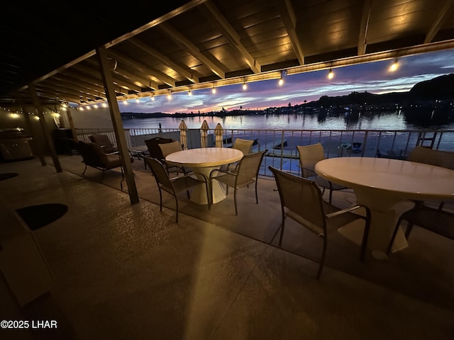 9378 Riverside Dr, Parker, AZ 85344 - patio at twilight with a water view and outdoor dining space