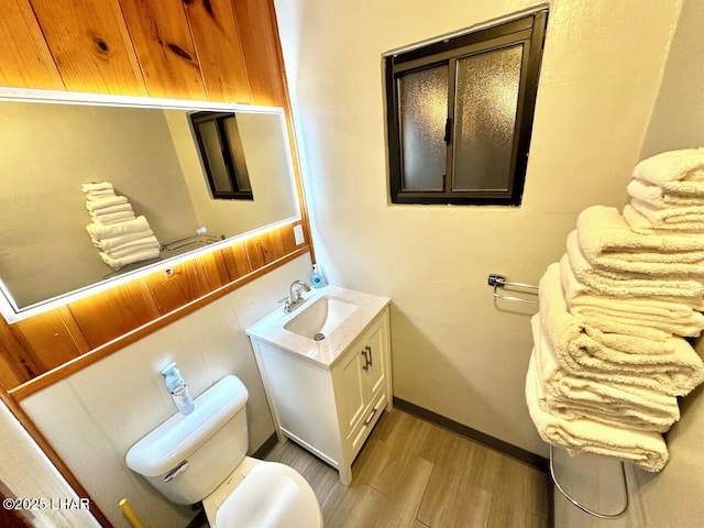 9378 Riverside Dr, Parker, AZ 85344 - bathroom with wood finished floors, toilet, vanity, and baseboards