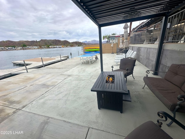 9378 Riverside Dr, Parker, AZ 85344 - view of patio with an outdoor fire pit, a dock, and a water and mountain view