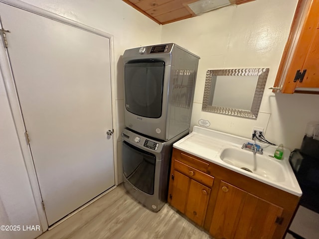 9378 Riverside Dr, Parker, AZ 85344 - laundry room with stacked washer / drying machine, cabinet space, and light wood-style floors