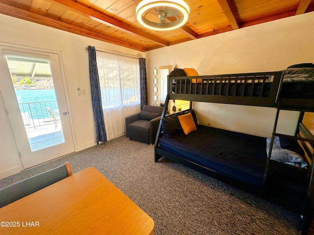 9378 Riverside Dr, Parker, AZ 85344 - carpeted bedroom featuring wooden ceiling, beamed ceiling, and access to exterior
