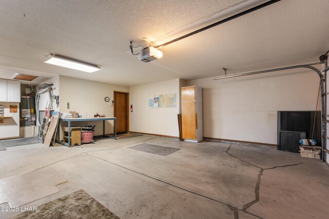 garage featuring water heater, a garage door opener, and baseboards