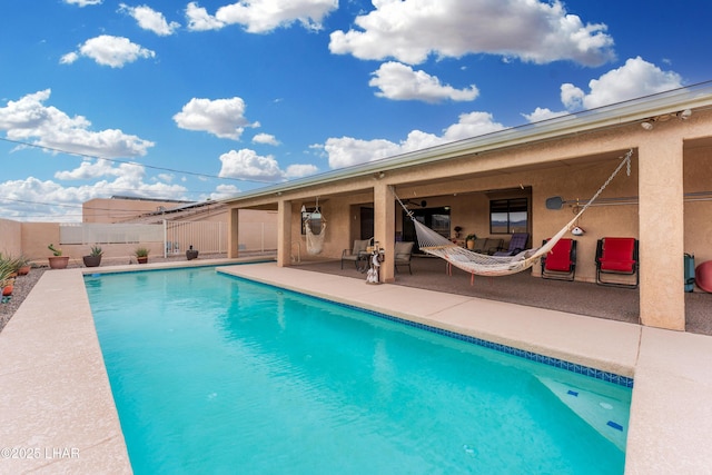 view of swimming pool with a fenced in pool, fence, and a patio area