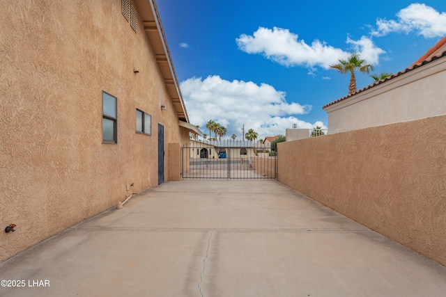 view of patio featuring fence and a gate