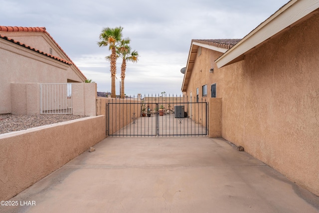 view of patio with a gate, cooling unit, and fence