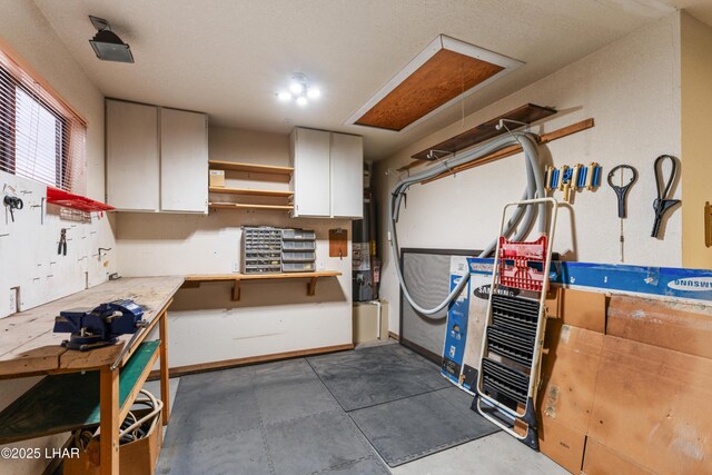 garage with gas water heater and a workshop area