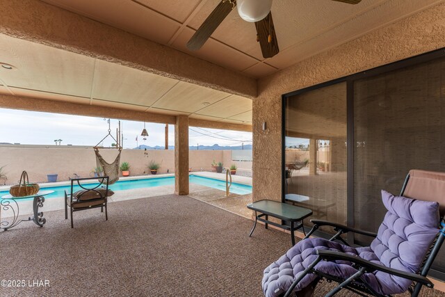 view of patio with a fenced in pool, a ceiling fan, and a fenced backyard