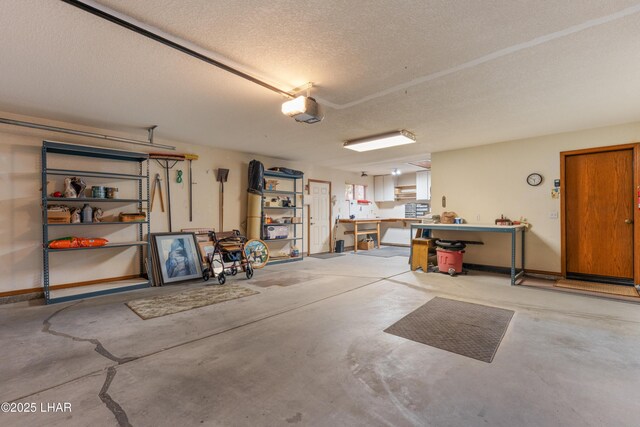 garage with a workshop area and a garage door opener