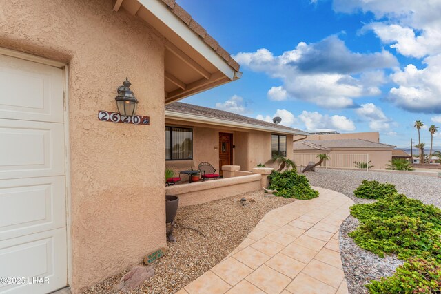 entrance to property with stucco siding