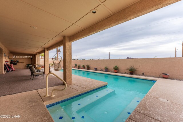 view of swimming pool featuring a patio area, a fenced in pool, and a fenced backyard