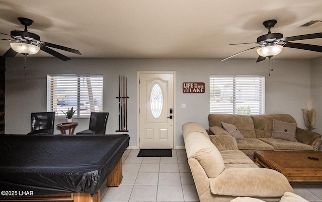 tiled living room featuring plenty of natural light and ceiling fan