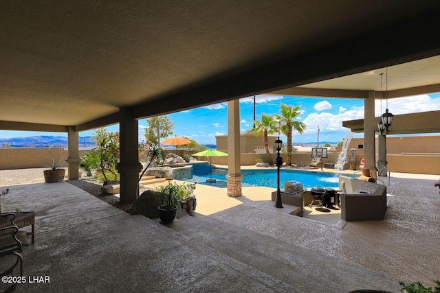 exterior space featuring a fenced in pool, a fenced backyard, and a patio