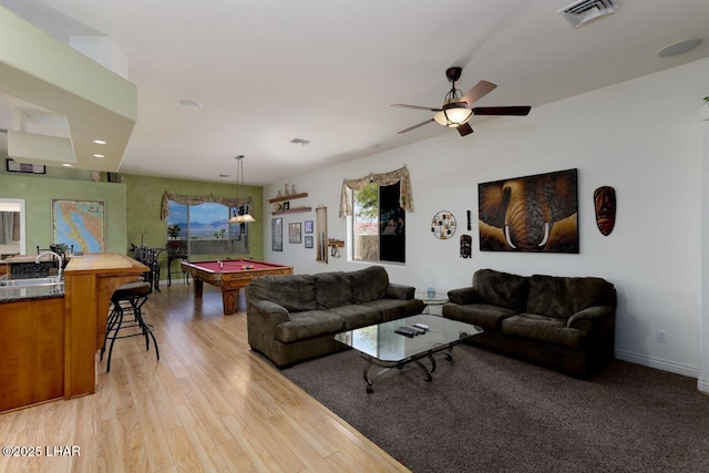 living area with light wood finished floors, baseboards, visible vents, a ceiling fan, and pool table