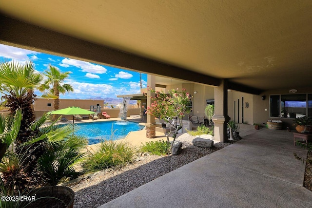 view of swimming pool with a patio area, fence, and a fenced in pool