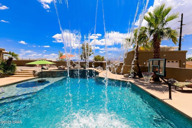 outdoor pool featuring a patio area and a fenced backyard