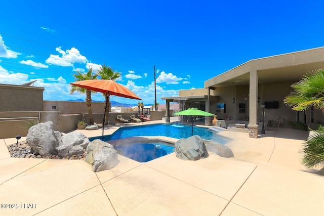 view of swimming pool featuring a fenced in pool, a fenced backyard, a patio, and an in ground hot tub