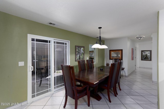 dining room with light tile patterned floors, baseboards, and visible vents