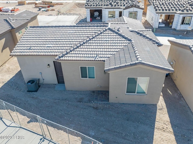 rear view of house featuring cooling unit