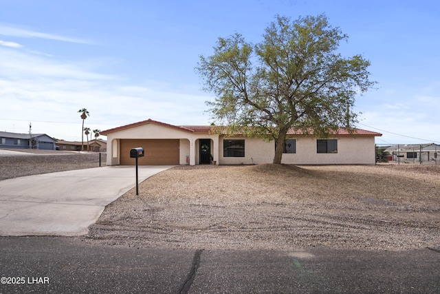 single story home featuring an attached garage, a tiled roof, driveway, and stucco siding