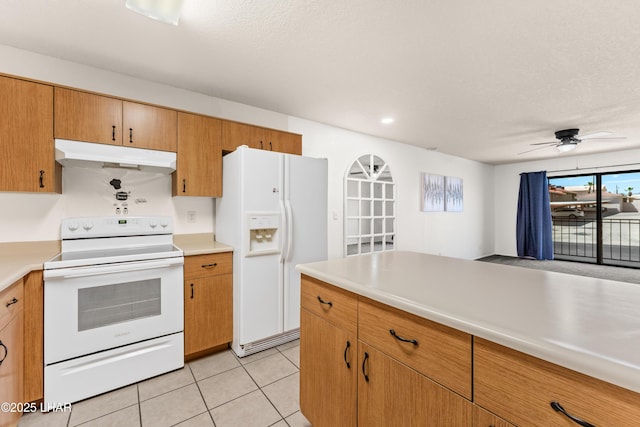 2094 Mesquite Ave Unit 113, Lake Havasu City, AZ 86403 - kitchen with white appliances, under cabinet range hood, light countertops, and light tile patterned floors