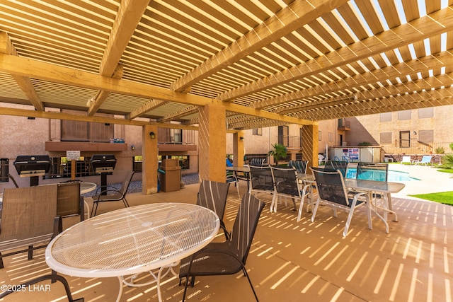 2094 Mesquite Ave Unit 113, Lake Havasu City, AZ 86403 - view of patio / terrace featuring outdoor dining area, a pergola, a community pool, and area for grilling