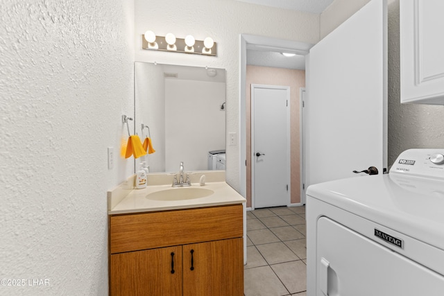 2094 Mesquite Ave Unit 113, Lake Havasu City, AZ 86403 - bathroom with washer / clothes dryer, vanity, a textured wall, and tile patterned flooring
